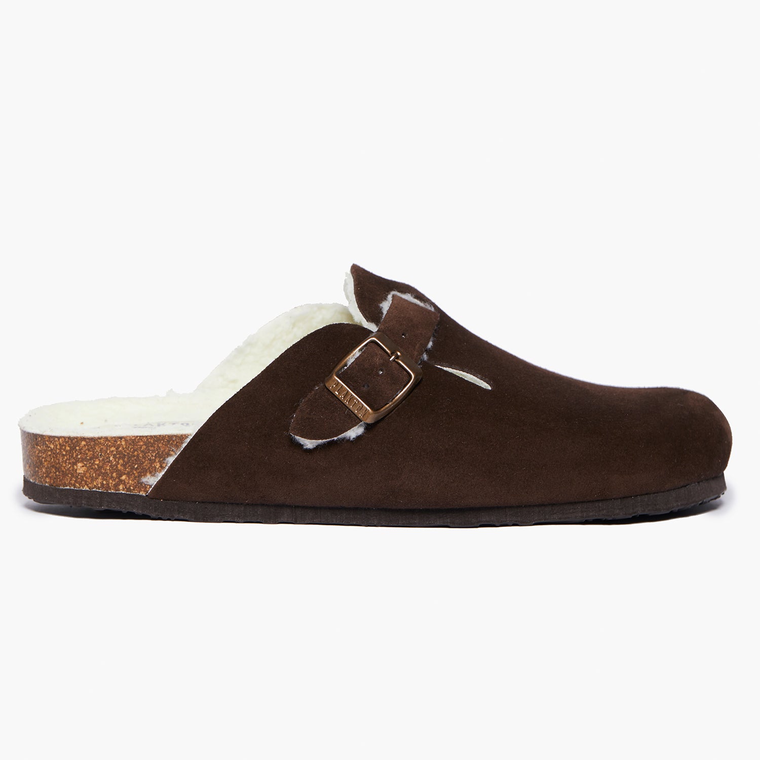 A dark brown suede slipper with a textured sole and an adjustable strap. Handmade in Spain