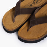 A pair of men's Acide sandals in chocolate brown nobuck leather. This view highlights the wide straps, the handmade stitching details, and the contoured anatomical cork footbed designed for support.