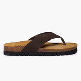 A top-down view of the brown Acide sandals by Plakton, focusing on the soft texture of the nobuck leather straps and the secure toe-post construction against the natural cork surface.