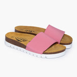 A pair of Barcadi Pink & White sandals resting in perfect balance. The wide, flexible pink textile uppers are designed to embrace the foot without pressure, while the deep-cupped cork footbeds showcase the anatomical support that defines Plakton’s handcrafted Spanish heritage.