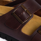 A detailed macro shot focusing on the Coffee Dakota Leather strap and the porous, sustainable Spanish cork. The image captures the high-quality grain of the leather, the precision of the tonal stitching, and the rugged beauty of the materials that define the Plakton "Nature's Hug" philosophy.
