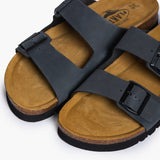 Close-up of the Plakton Barna two-strap sandal in grey, showing adjustable buckles, natural cork footbed, and soft leather upper.