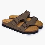 A pair of Barna sandals angled to highlight the depth of the heel cups and the soft texture of the khaki nubuck. The two adjustable straps with antique-bronze buckles sit atop a rich tan suede lining, emphasizing a handcrafted design that balances rugged durability with a gentle "Nature’s Hug."