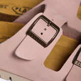 An extreme close-up of the Beta strap, focusing on the fine, velvety grain of the Salmon Nubuck leather. A sturdy metallic buckle embossed with "PLAKTON" is the centerpiece, while the soft-focus background highlights the porous, sustainable Spanish cork, emphasizing the high-quality handcrafted heritage.