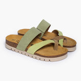 A pair of Bloom sandals in Multi-Green Suede, angled to reveal the deep-seated heel cups and the smooth transition of the handcrafted cork base. The multi-tonal green straps overlap elegantly, resting atop a plush tan suede lining that highlights the signature "Nature’s Hug" comfort.