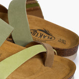 An extreme close-up of the Bloom’s upper, focusing on the rich, fibrous texture of the Multi-Green suede. The shot highlights the precise stitching and the tonal shift between the green layers, while the soft-focus background shows the porous Spanish cork, emphasizing its premium handcrafted heritage.