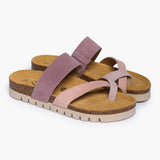 A pair of Bloom sandals in Multi-Pink Suede, angled to show the deep-seated heel cups and the smooth transition of the cork base. The layered pink straps cross elegantly over the foot, resting atop a plush tan suede lining that emphasizes the signature "Nature’s Hug" philosophy.
