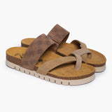 A pair of Bloom sandals in Multi-Tan Suede, angled to reveal the deep-seated heel cups and the smooth transition of the cork base. The tonal tan straps cross elegantly over the foot, resting atop a plush suede lining that emphasizes the signature Plakton "Nature’s Hug" comfort.