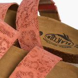 Macro shot of the Plakton Brynn sandal showing the "Made in Spain" brand logo on the cork footbed and the textured floral embossing on the peach suede straps.