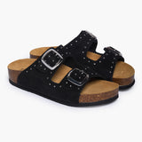A pair of Plakton CP Beta black studded suede sandals shown from a three-quarter angle, highlighting the premium suede texture, silver hardware, and the suede-lined ergonomic cork footbed.