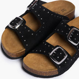 A top-down close-up shot of the Plakton CP Beta sandals, showcasing the intricate silver studs bordering the black suede straps and the wide, comfortable toe area on the cork footbed.