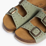 An overhead view looking into the CP Beta footbeds, where the biologically contoured cork provides a natural cradle for the foot. The mint-colored studded straps frame the "Plakton Memory Cushion" branding, showcasing a design that balances playful Mediterranean aesthetics with the organic requirements of foot health.