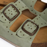 An extreme close-up focusing on the velvety mint suede and the precision-set metallic studs. The "PLAKTON" embossed buckle is visible alongside the porous, breathable texture of the natural cork, highlighting the contrast between industrial-inspired accents and pure, earth-born materials.