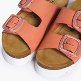 Looking directly down into the Calla footbeds, where the biologically contoured cork follows the foot's natural impression. The soft peach nubuck straps frame the "Plakton Memory Cushion" branding at the heel, illustrating a design that honors human anatomy through the use of renewable, earth-born materials.