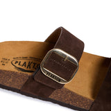 Brown sandal with a metal buckle on a white background