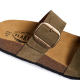 Brown sandal with a strap and visible branding on a white background